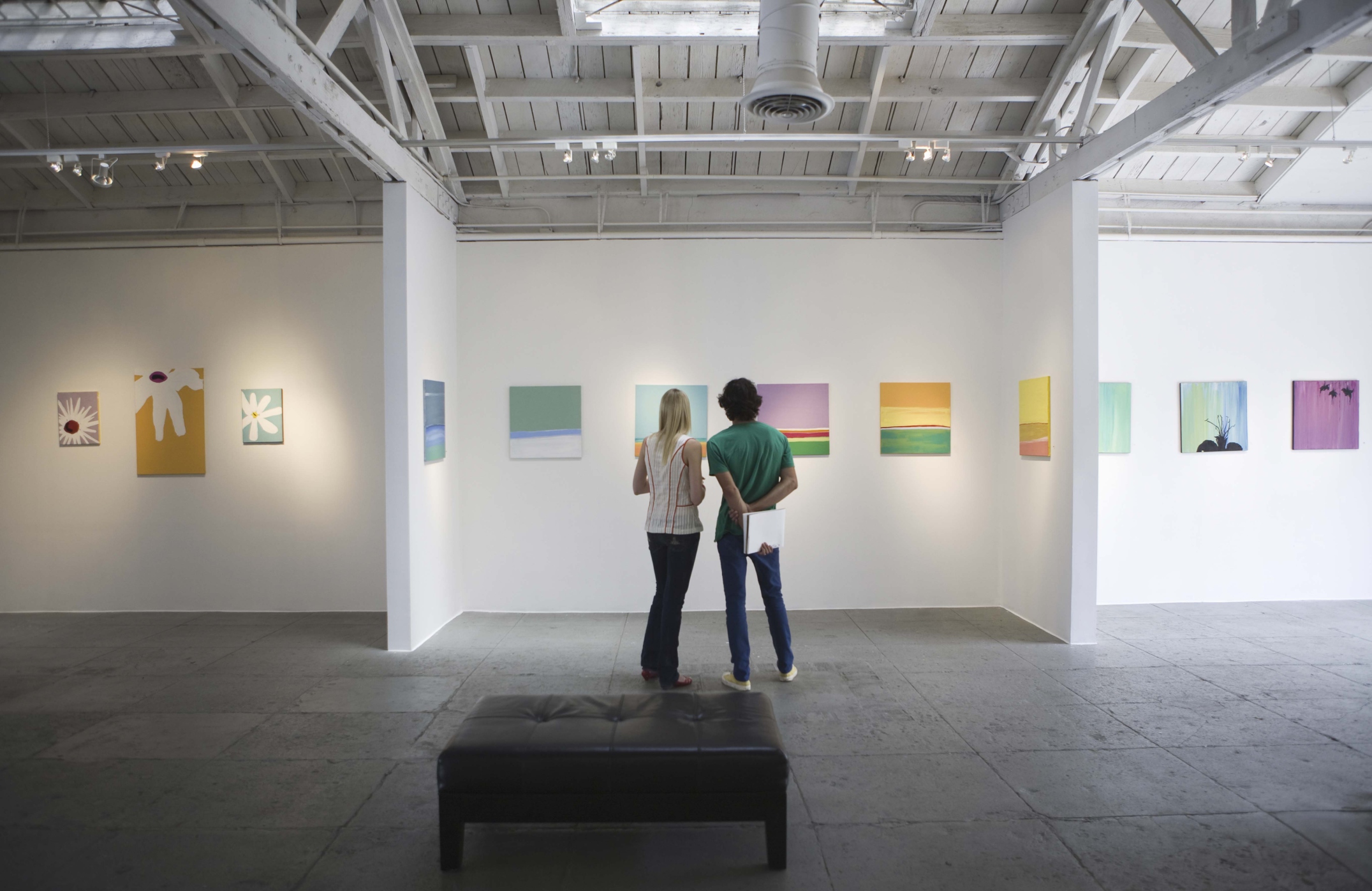 Couple looking at painting in art gallery